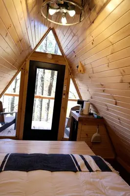 a room with a bed and a window in a cabin at Secluded A-Frame Incredible for Water Activities by Tappan Lake in Ohio in Deersville