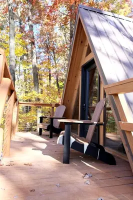 a tent with two chairs and a bench on a patio at Amazing A-Frame by Tappan Lake Perfect for Outdoor Lovers in Ohio in Deersville