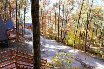 a path in the woods with a fence and trees at Amazing A-Frame by Tappan Lake Perfect for Outdoor Lovers in Ohio in Deersville