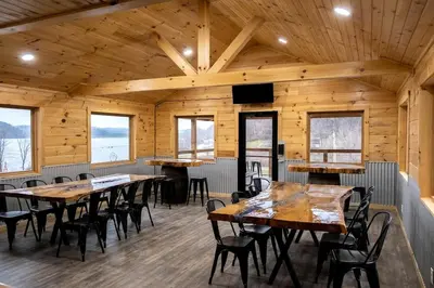 a dining room with wooden ceilings and tables and chairs at Group Friendly Cabin with Spa on the Deck near Tappan Lake in Ohio in Deersville