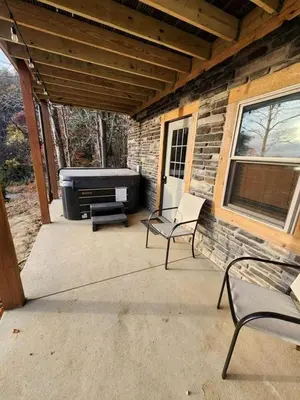 a patio with two chairs and a grill at Lakeview Cabin by Tappan Lake, Perfect for Groups with Hot-Tub in Ohio in Deersville