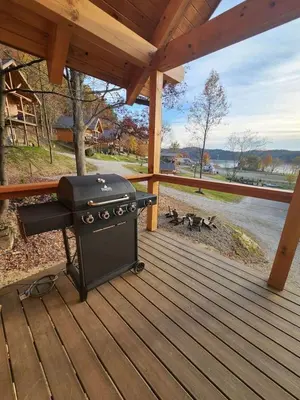 a grill on a deck with a group of dogs at Lakeview Cabin by Tappan Lake, Perfect for Groups with Hot-Tub in Ohio in Deersville