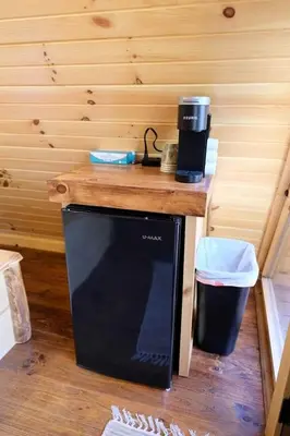 a microwave sitting on top of a wooden counter at Two Person A-frame near Tappan Lake, Ideal to Reconnect with Nature in Ohio in Deersville
