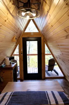 a room with a large window in a cabin at Two Person A-frame near Tappan Lake, Ideal to Reconnect with Nature in Ohio in Deersville