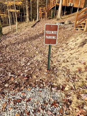 a sign in the middle of a pile of leaves at Pet-Friendly Tree Cabin by Tappan Lake with Lofted Space in Ohio in Deersville