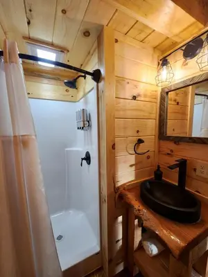 a bathroom with a sink and a tub and a toilet at Pet-Friendly Tree Cabin by Tappan Lake with Lofted Space in Ohio in Deersville