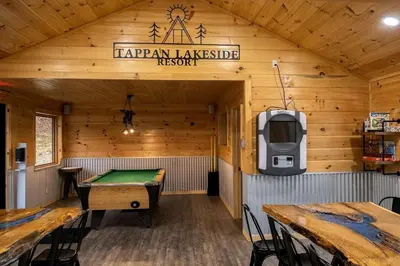 a room with a ping pong table and a tv at Pet-Friendly Tree Cabin by Tappan Lake with Lofted Space in Ohio in Deersville