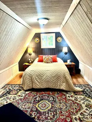a bedroom with a large bed and a rug at Gorgeous Secluded Cabin with Hiking Trails Near in Frenchburg, Kentucky in Frenchburg