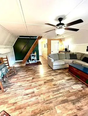 a living room with a couch and a ceiling fan at Gorgeous Secluded Cabin with Hiking Trails Near in Frenchburg, Kentucky in Frenchburg