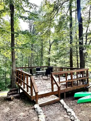 two wooden benches in a park with trees at Gorgeous Secluded Cabin with Hiking Trails Near in Frenchburg, Kentucky in Frenchburg
