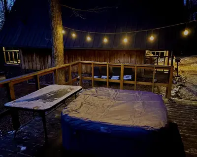 a bed and a bench in front of a cabin at Gorgeous Secluded Cabin with Hiking Trails Near in Frenchburg, Kentucky in Frenchburg