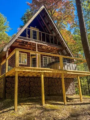 a cabin in the woods with a wrap around deck at Gorgeous Secluded Cabin with Hiking Trails Near in Frenchburg, Kentucky in Frenchburg