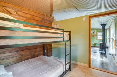 a bedroom with two bunk beds in a house at Pond and Fire Pit Charming Log Cabin near Blue Rock in Blue Rock