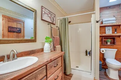 a bathroom with a sink and a toilet at Pond and Fire Pit Charming Log Cabin near Blue Rock in Blue Rock