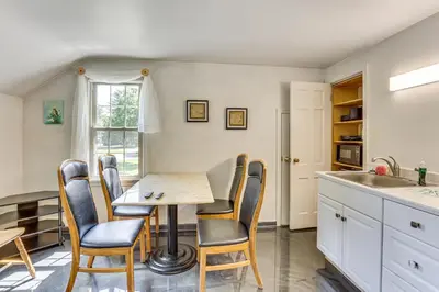 a kitchen with a table and chairs and a sink at 1 Mi to Dtwn Salem Apt with Garage Access! in Salem