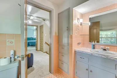 a bathroom with a sink and a mirror at 1 Mi to Dtwn Salem Apt with Garage Access! in Salem