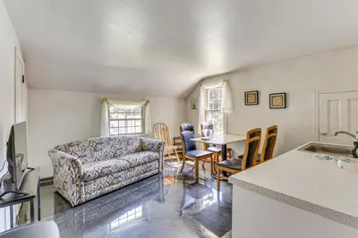 a living room with a couch and a table at 1 Mi to Dtwn Salem Apt with Garage Access! in Salem