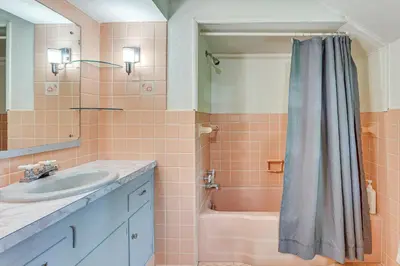 a bathroom with a sink and a tub and a shower at 1 Mi to Dtwn Salem Apt with Garage Access! in Salem
