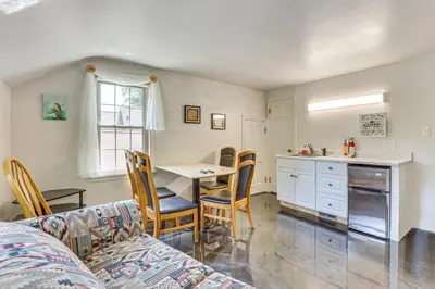 a kitchen and dining room with a table and chairs at 1 Mi to Dtwn Salem Apt with Garage Access! in Salem