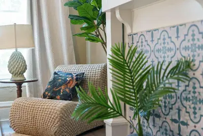 a living room with a couch and a plant at Merion Village Residences - Escape the Hustle & Bustle in Columbus