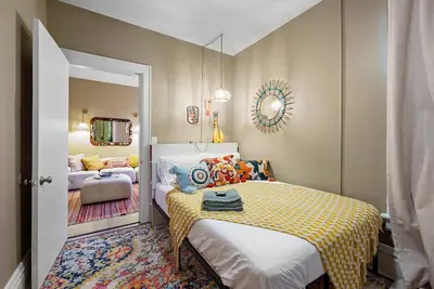 a bedroom with a bed and a living room at Merion Village Residences - Escape the Hustle & Bustle in Columbus