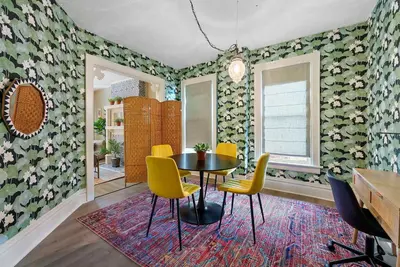 a dining room with a table and yellow chairs at Merion Village Residences - Escape the Hustle & Bustle in Columbus