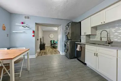 a kitchen with white cabinets and a table and appliances at CGV - Unique and Memorable 3BDR Stay in Columbus