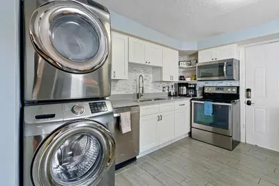 a kitchen with a washer and a washing machine at CGV - Unique and Memorable 3BDR Stay in Columbus