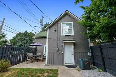a small house with a white door and a table at CGV - Unique and Memorable 3BDR Stay in Columbus