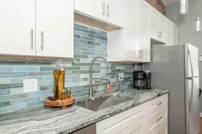 a kitchen with a sink and a refrigerator at Findlay Market Suite 3 - For 2 in Cincinnati