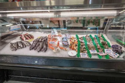 a display case with different types of meats and vegetables at Findlay Market Suite 3 - For 2 in Cincinnati