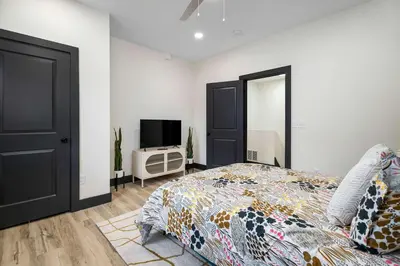 a bedroom with a bed and a flat screen tv at The Dayton Dream house in Dayton