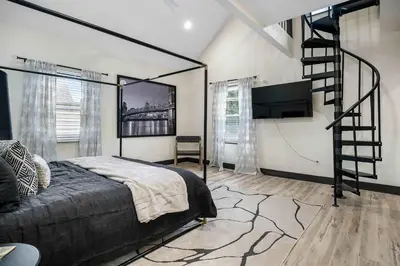 a bedroom with a bed and a flat screen tv at The Dayton Dream house in Dayton