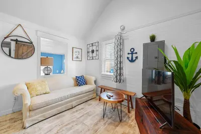 a living room with a couch and a table at GV - Romantic Beach Getaway in Columbus