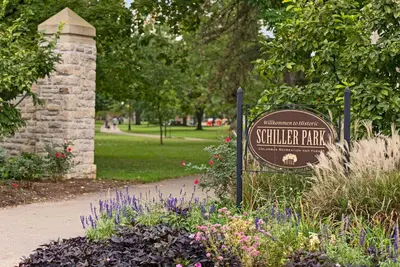a sign in a park with flowers and a path at GV - Romantic Beach Getaway in Columbus