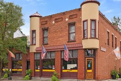a brick building with american flags in front of it at GV - Romantic Beach Getaway in Columbus