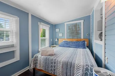 a blue bedroom with a bed with a blue wall at GV - Romantic Beach Getaway in Columbus
