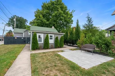 a small house with a bench in a yard at GV - Romantic Beach Getaway in Columbus