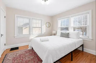 a bedroom with a large white bed with two windows at Tibet Twins 2 Retreat for 6 in Columbus