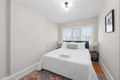 a bedroom with a white bed and a window at Tibet Twins 2 Retreat for 6 in Columbus
