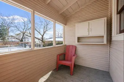 a red chair sitting in a room with a window at Tibet Twins 2 Retreat for 6 in Columbus