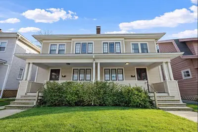 a large white house with a porch at Tibet Twins 2 Retreat for 6 in Columbus