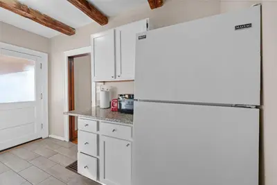 a kitchen with white cabinets and a refrigerator at Tibet Twins Suites For 12 in Columbus