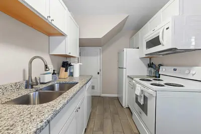 a kitchen with white appliances and a sink at Tibet Twins Suites For 12 in Columbus
