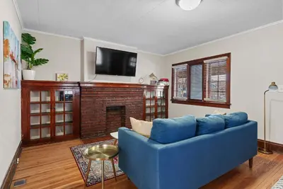 a blue couch in a living room with a fireplace at Tibet Twins Suites For 12 in Columbus