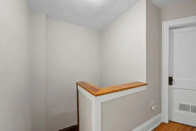 a room with a white wall with a wooden shelf at Tibet Twins Suites For 12 in Columbus