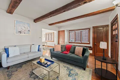 a living room with a couch and a table at Tibet Twins Suites For 12 in Columbus