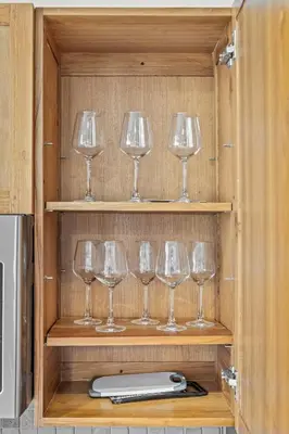 a row of wine glasses sitting on a shelf at 1 BD Apt l Downtown l Parking l Fast Wi-Fi l Café in Cleveland