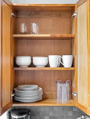 a cabinet filled with plates and bowls and dishes at 1 BD Apt l Downtown l Parking l Fast Wi-Fi l Café in Cleveland