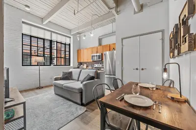 a kitchen and living room with a table and a couch at 1 BD Apt l Downtown l Parking l Fast Wi-Fi l Café in Cleveland